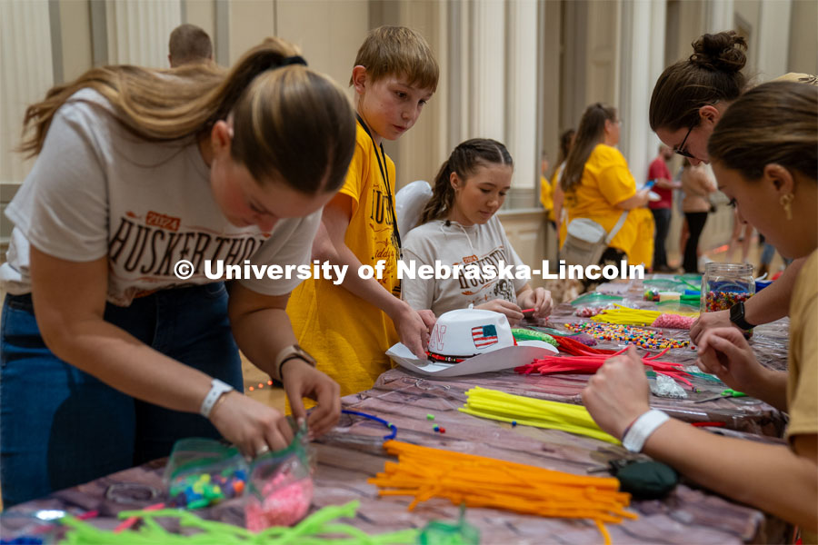 University of Nebraska-Lincoln student, Ava Strunk, helps create decorations for a cowboy hat at Dance Marathon. University of Nebraska–Lincoln students raised $83,702.24 during the annual HuskerThon. Also known as Dance Marathon, the event is part of a nationwide fundraiser supporting Children’s Miracle Network Hospitals. The annual event, which launched in 2006, is the largest student philanthropic event on campus. The mission of the event encourages participants to, “dance for those who can’t.” All funds collected by the Huskers benefit the Children’s Hospital and Medical Center in Omaha. March 2, 2024. Photo by Kirk Rangel.