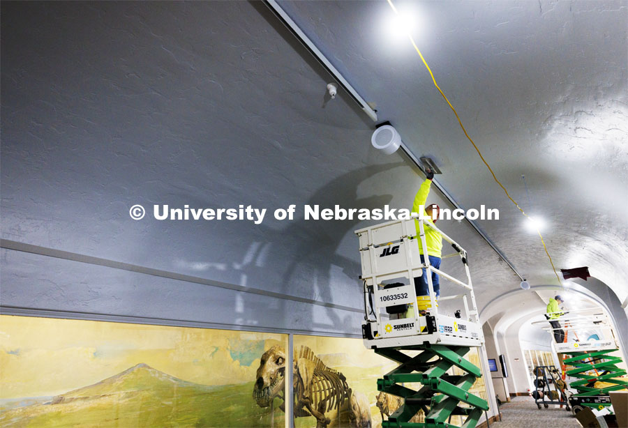 Sara Lopez with Scott’s Quality Plastering and Stucco smooths the ceiling next to the new lighting tracks on the second floor in Morrill Hall. Workers are rushing to finish renovations to improve accessibility and better protect its exhibits and research specimens so the University of Nebraska State Museum and Mueller Planetarium can reopen to the public on March 15, 2024. March 4, 2024. Photo by Craig Chandler / University Communication and Marketing.