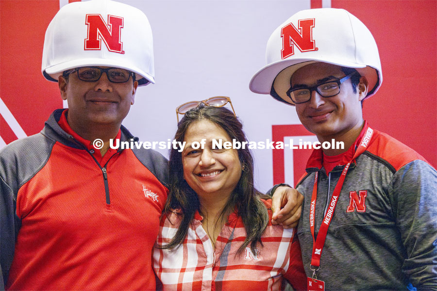 Shrey Agarwal poses with his family wearing oversized Nebraska baseball caps. Admitted Student Day is UNL’s in-person, on-campus event for all admitted students. March 23, 2024. Photo by Craig Chandler / University Communication and Marketing.