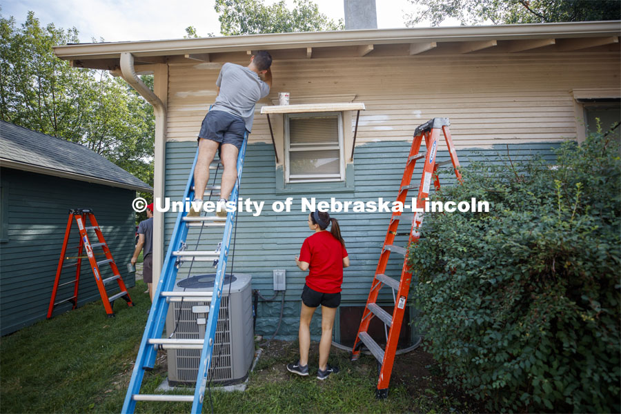 First year law students, faculty and staff paint two Lincoln houses. The painting is a yearly tradit