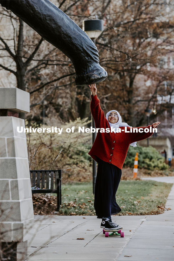 201118_Campus_006p.jpg Khadieja Abuzaho, freshman from Lincoln, touches the foot of Archie the Mammoth in front of the Nebr