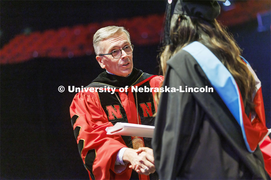 Chancellor Ronnie Green congratulates each doctoral and masters degree graduates during the ceremony