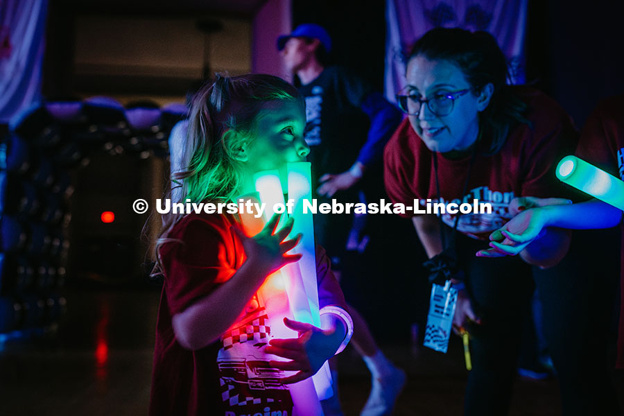 Coralie, a miracle child, holds glow sticks during the Huskerthon rave. Huskerthon 2025, also known 