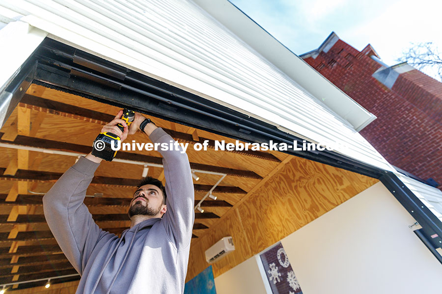 241209_Art_Chapel_08.jpg Devyn Beekman, third year architecture student, removes a weather strip from the entrance. Art Chape