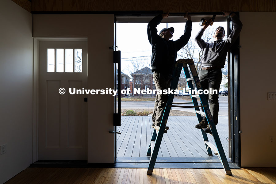 241209_Art_Chapel_09.jpg Third year architecture students Ethan Watermeier, left, and Devyn Beekman work together to place a