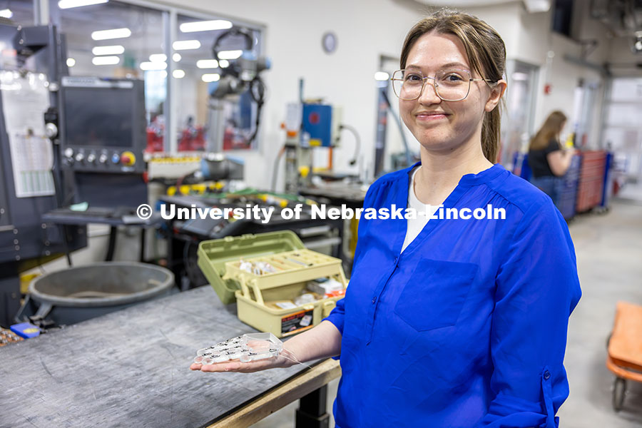 250414_Robotics_Fellows_9.jpg Teresa Monsees, a senior mechanical engineering major, holds the prototype of a robotic hand that wi