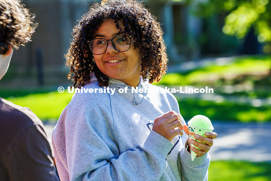 250503_End of Year Bash_434.jpg A UNL student talks to her friend after getting a snow cone at the End of Year Bash on East Campus.