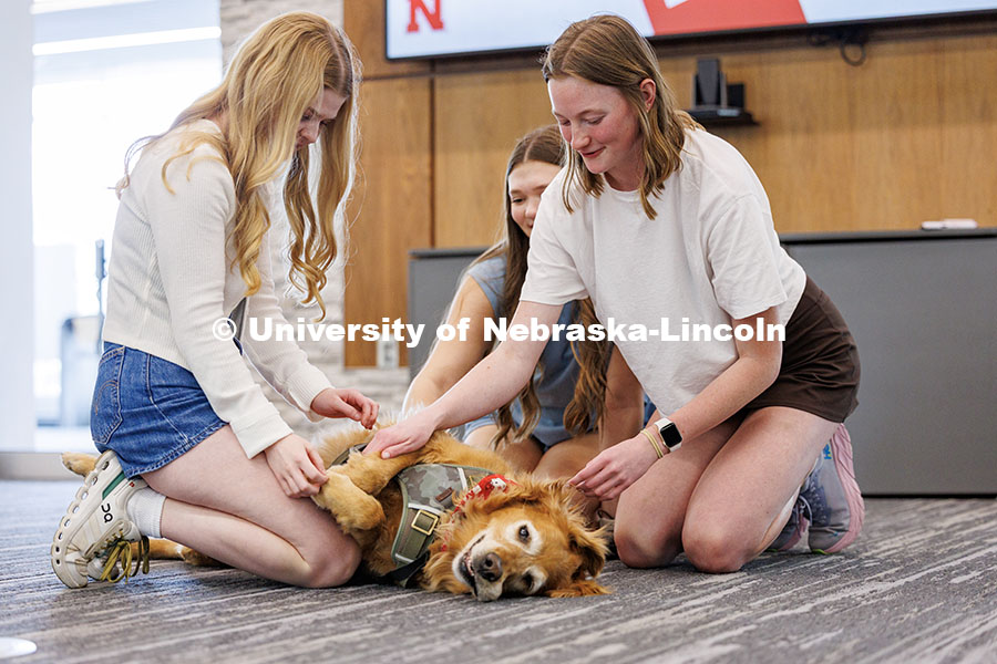 250507_Big_Red_Pawp_Up_129.jpg (Left to right) Izzy Krumwiede, Gracie Persinger and Sydney Hatch pet Remy the golden retriever duri