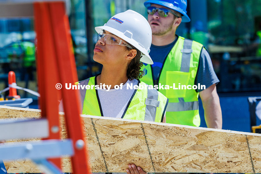 250508_Const_Mgmt_300.jpg Senior, Jaeda Jeffries, holds a plank of wood as she works on her group’s shed for her Vertical Co