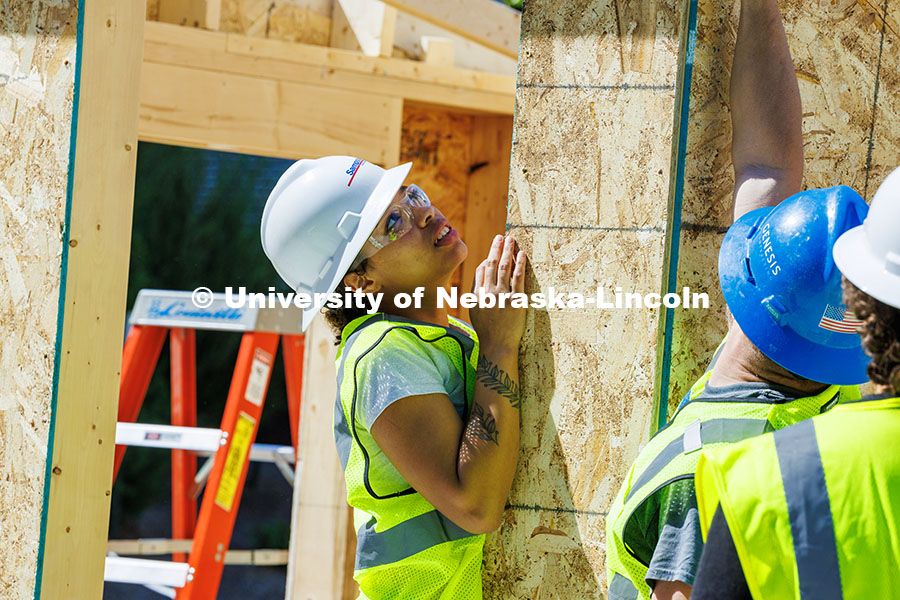 250508_Const_Mgmt_363.jpg Senior, Jaeda Jeffries, holds a plank of wood as she works on her group’s shed for her Vertical Co