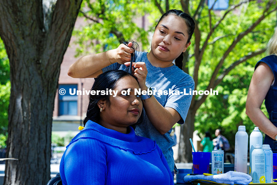 250509_Big_Red_Finale_006.jpg Bhavana Sreekumar, a Community and Regional Planning Graduate Student, gets her hair braided by an e