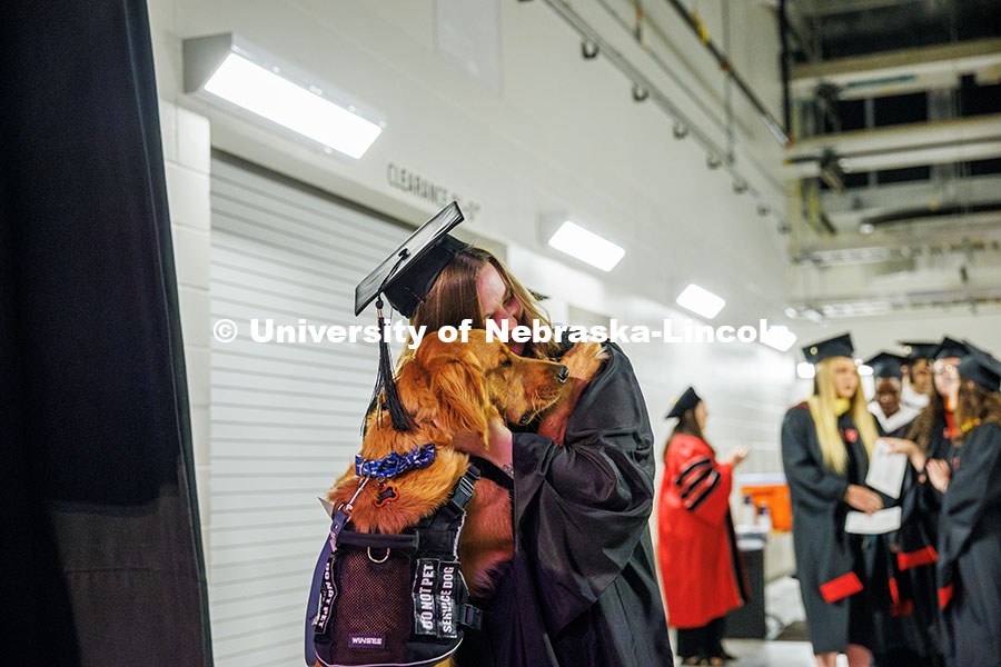 250516_Grad_Commencement_0215.jpg Educational Administration Graduate student, Desteny Miller, hugs her service dog, Maverick, prior t