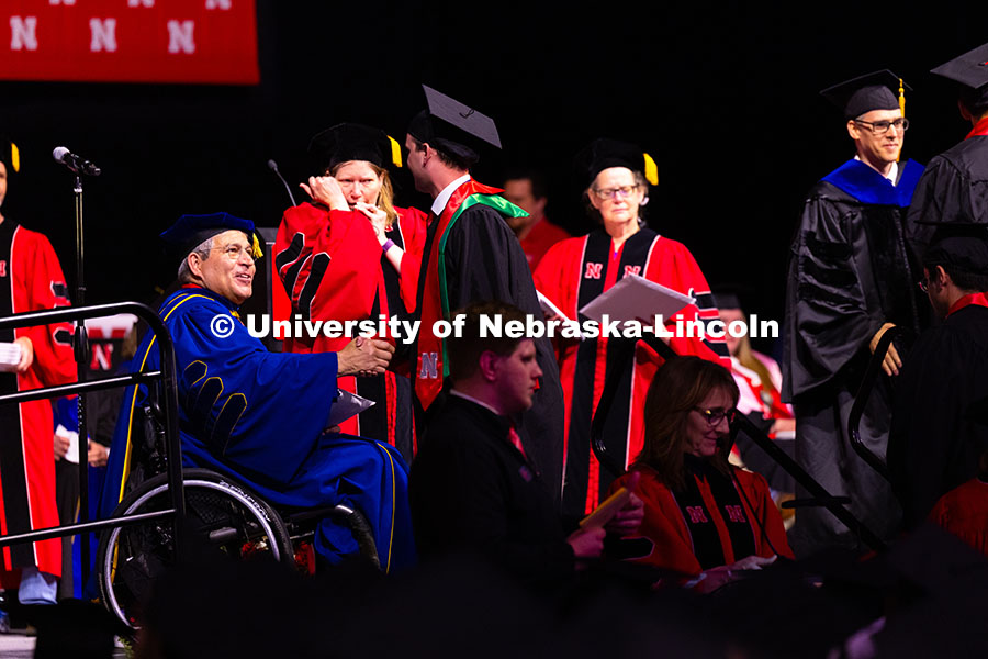 Construction Management graduate Quinny Brumbaugh shakes hands with College of Engineering Dean Lanc