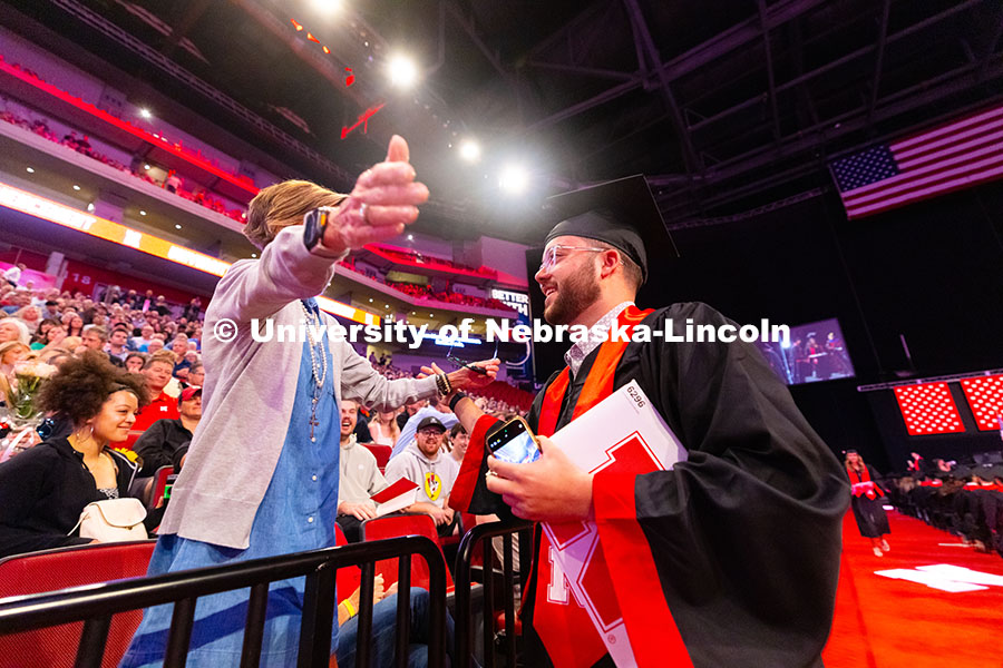Business Administration graduate Jarrett Michie hugs his mother, Kim Michie, after receiving his dip