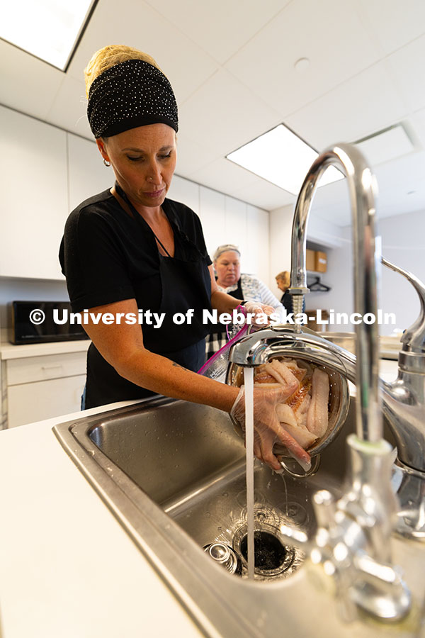 250604_Training_Academy_9540.jpg Dusty Stevens drains water from a thawed package of whitefish fillets, which were then rubbed with b