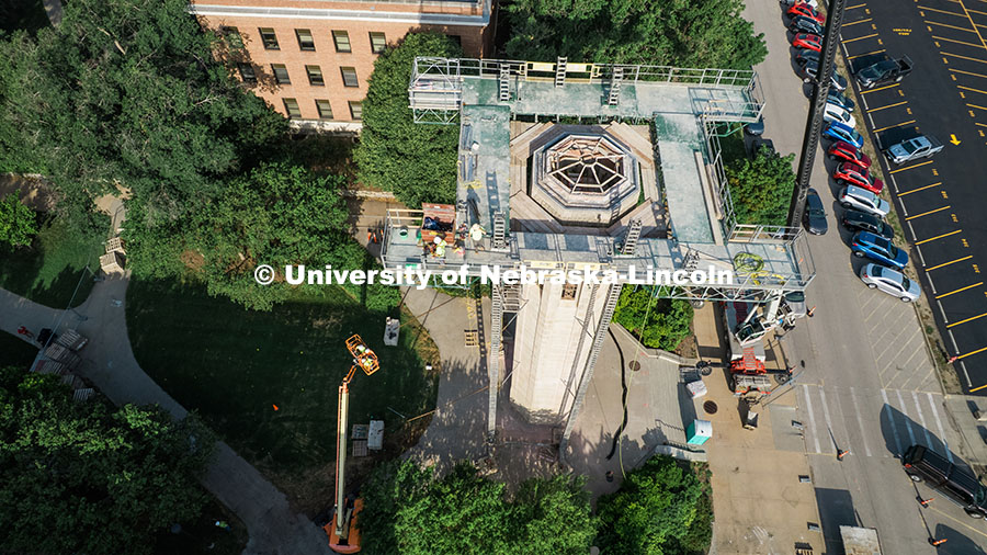 250623_Mueller_0362.jpg Construction workers stand on scaffolding near the top of Mueller Tower. The tower is undergoing a r