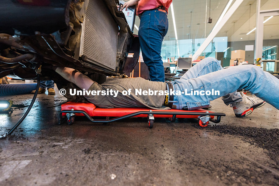 250623_Engineering_1831.jpg Ian Gouldie, a UNL robotics engineering major, works underneath the UNL Figure 8 Racing team car ins