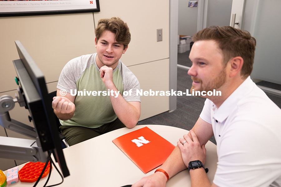 Adam Christiansen, Academic Navigator in the Explore Center, speaks with Jacob Behnk, a senior study