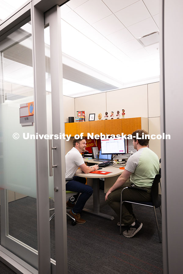 Adam Christiansen, Academic Navigator in the Explore Center, speaks with Jacob Behnk, a senior study