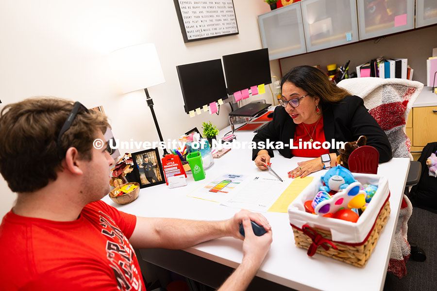 250625_CAST_Team_1796.jpg Mari Beck talks with Jacob Behnk, a senior studying Spanish and global studies, in her office in the