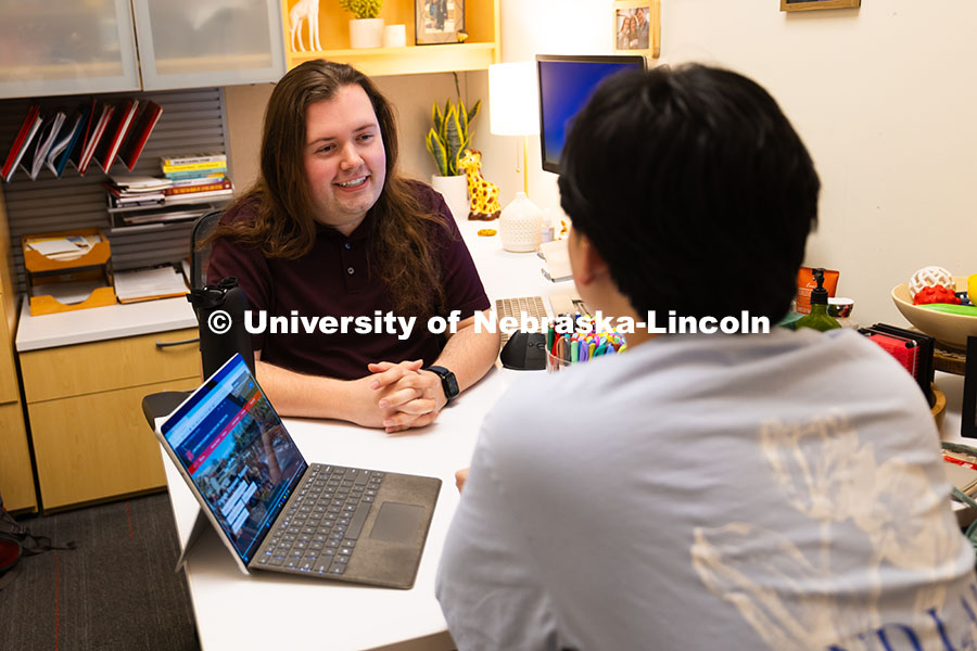 250625_CAST_Team_1840.jpg Jordan Heim chats with Jimmy Truong, a junior studying supply chain management, in his office in the