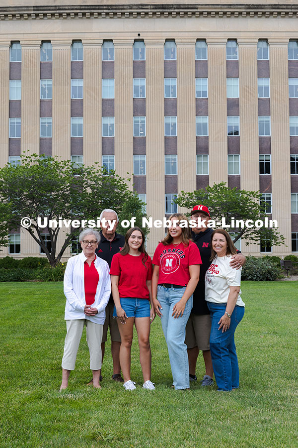 Sisters Madison and Lauren Haring pose with their family in front of Love Library. The Haring family