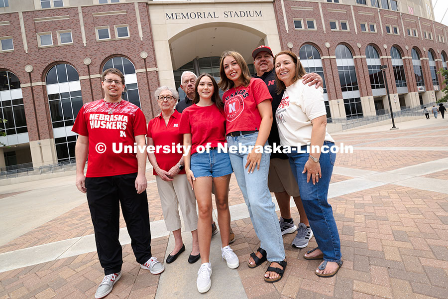 Sisters Madison and Lauren Haring pose with their family, plus Kevin Coleman, outside of Memorial St