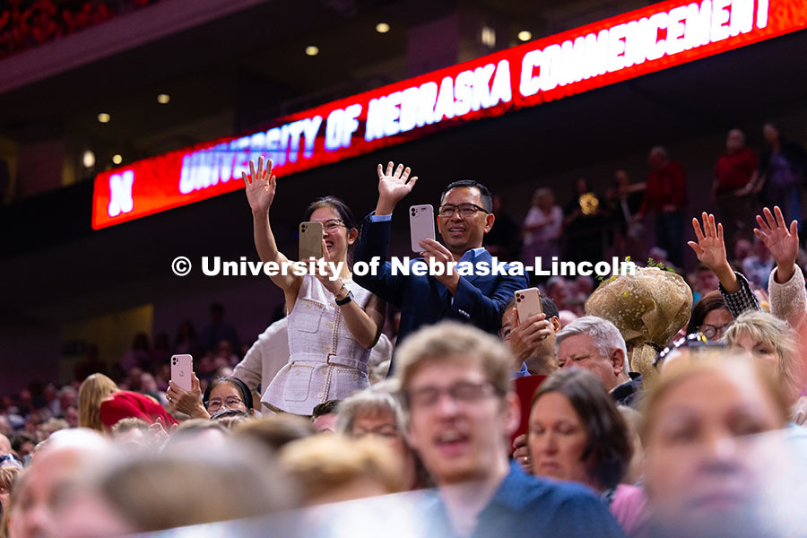 Family members cheer and record video of their student in Pinnacle Bank Arena during the processiona
