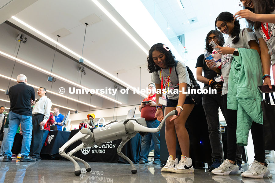 250523_Science_Olympiad_9047.jpg A robot dog shakes hands with Laakshitha Mittapalli, a member of the Science Olympiad team from Cumb