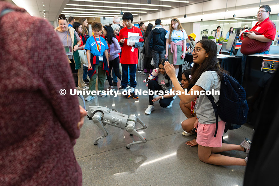 250523_Science_Olympiad_9057.jpg Sahana Sudarsan waves to a camera as she and her friends and teammates, Laakshitha Mittapalli (middl