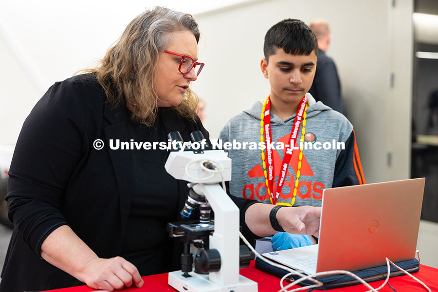250523_Science_Olympiad_9088.jpg Karrie Weber, Professor of Microbiology, points out bacteria on a slide to Kavin, a Lincolnshire, Il