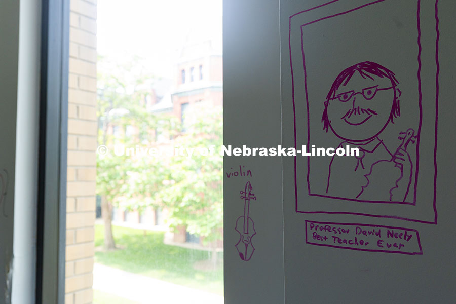 250530_Westbrook_9427.jpg A student rendering of David Neely, Professor of Violin, drawn on the wall of his office in the old