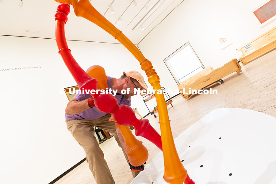 250729_Sheldon_3137.jpg Delan Lonowski, an on-call exhibition technician for the Sheldon Museum of Art, fits one of the smal