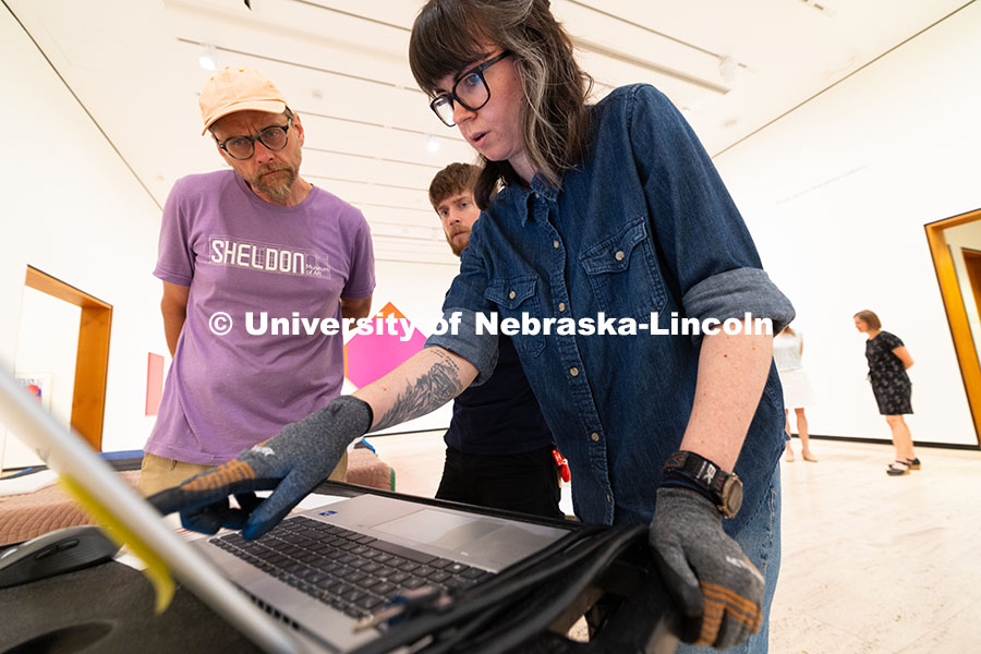 250729_Sheldon_3158.jpg Delan Lonowski (left) and Quentin Fortney (right), on-call exhibition technicians, move part of a sc