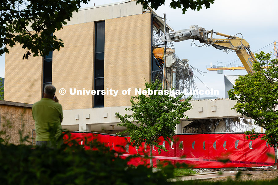 250805_Westbrook_3180.jpg A spectator records video as an excavator removes the windowpanes during the demolition of the north
