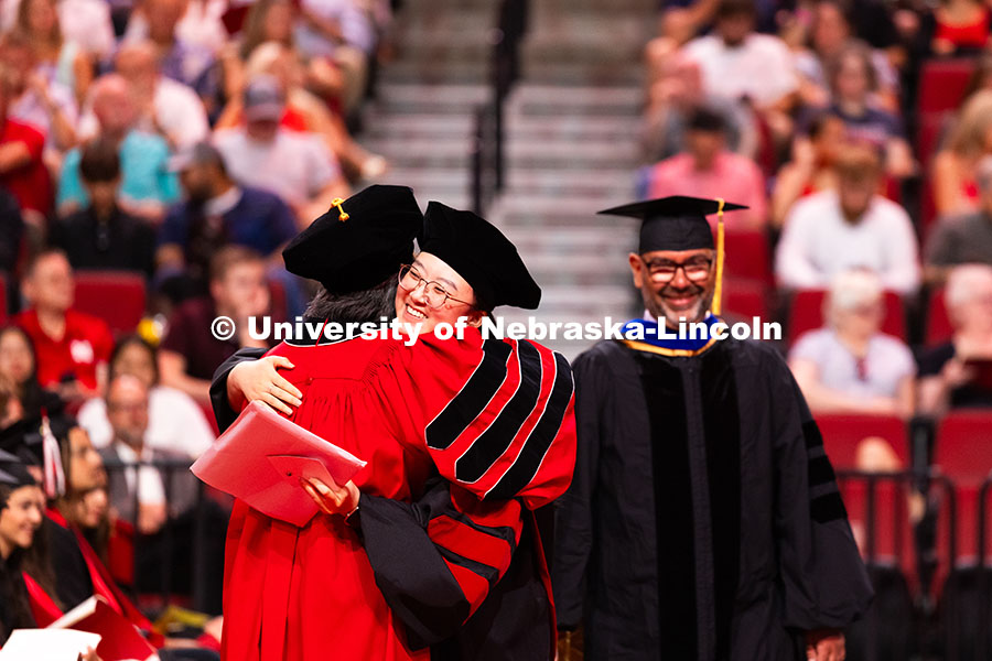 250816_Commencement_3713.jpg Weiman Xu hugs a professor after receiving her doctorate during the summer commencement ceremony. Su