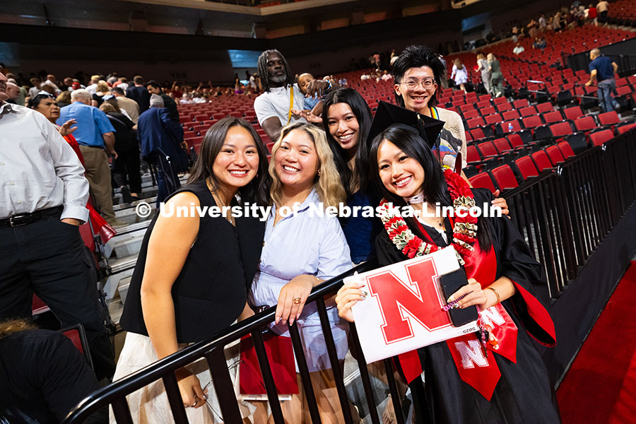 250816_Commencement_3747.jpg Elizabeth Nguyen poses for a photo with family and friends after receiving her bachelor's degree at