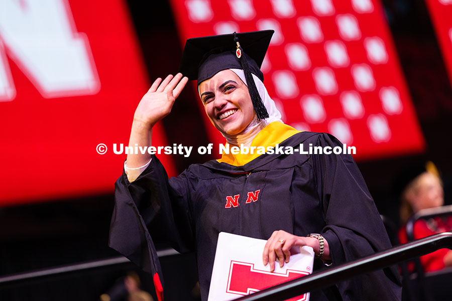 250816_Commencement_3752.jpg Amasi Ali Hassan Hajahja waves toward family and friends after receiving her master's degree during