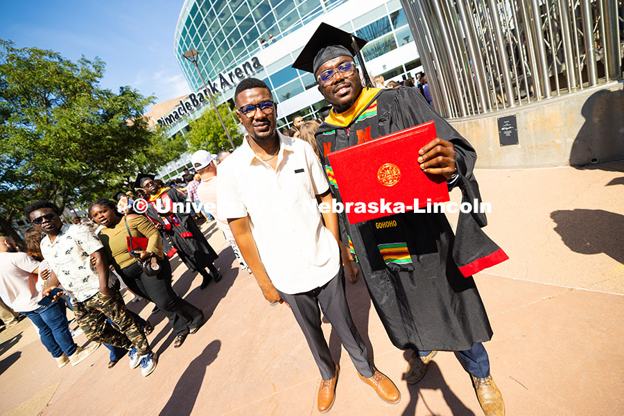 250816_Commencement_3780.jpg Dela Gohoho holds up his degree outside of Pinnacle Bank Arena. He received his master's in chemical