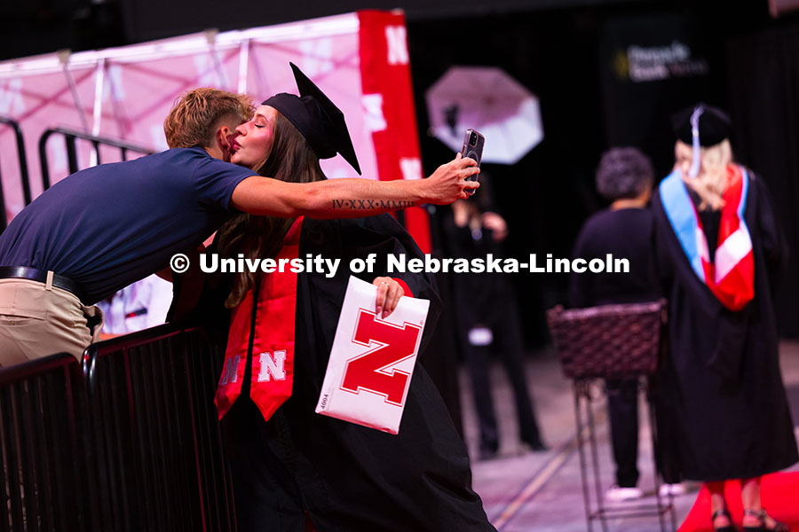 250816_Commencement_3801.jpg Payton Kleidosty gives her partner, Kyle Hansen, a kiss after receiving her diploma. Hansen waited a