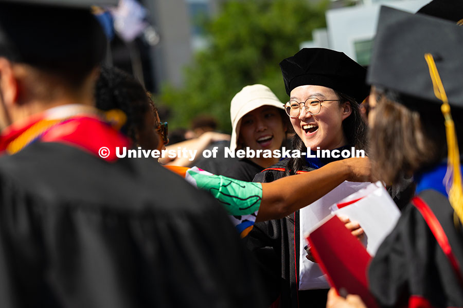 250816_Commencement_3842.jpg Weiman Xu gets a hug from former classmate and previous graduate, Genese Clark, after the summer com