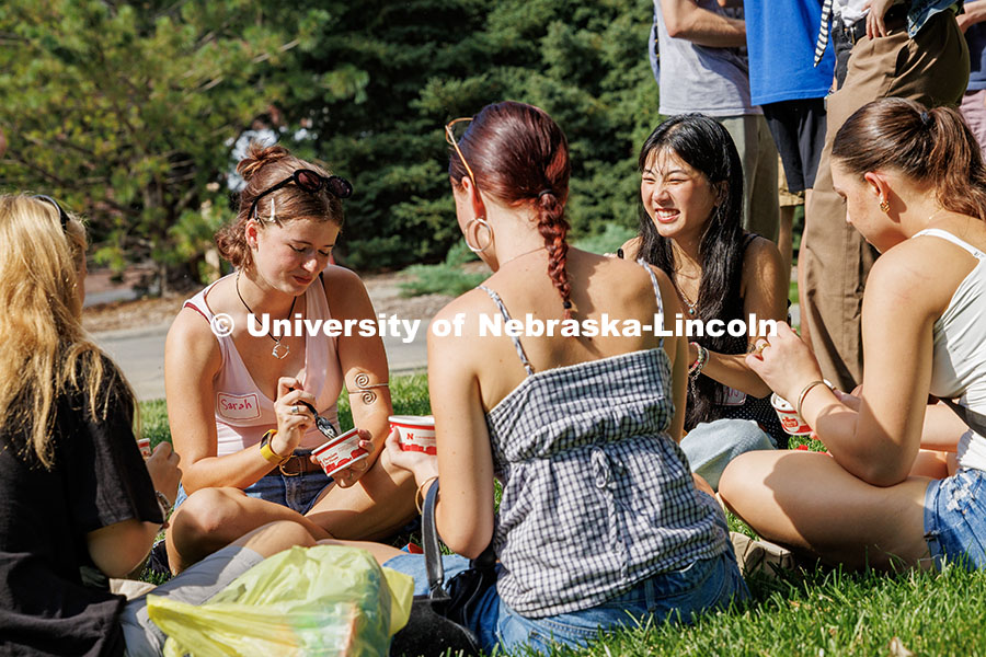 250821_FPA_Welcome_046.jpg Freshman, Sarah Nielsen and Sloan Inbody laugh while enjoying ice cream from the Dairy Store at the