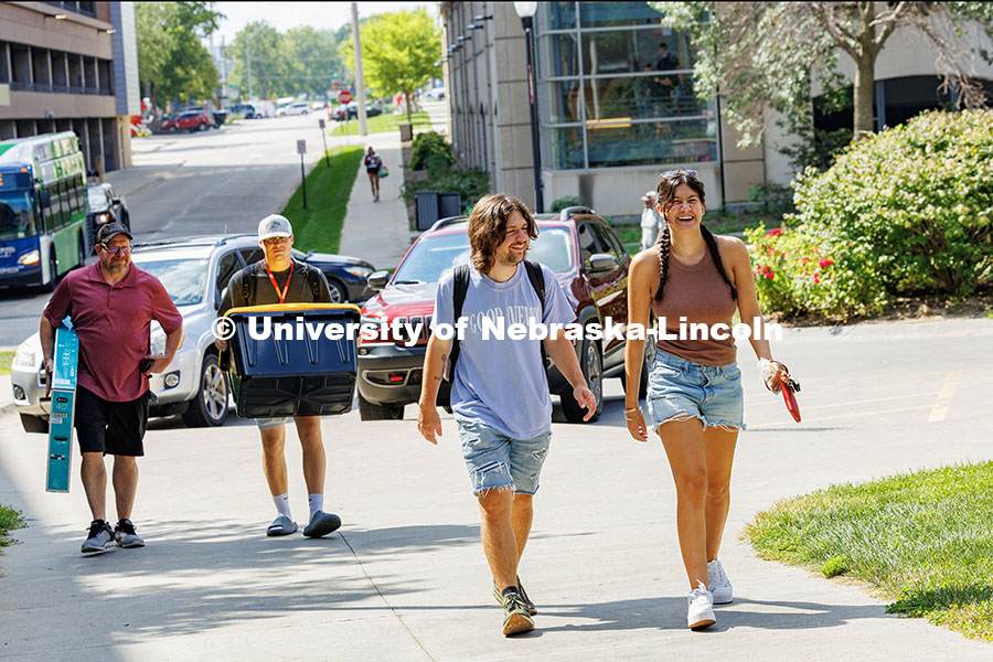 Meghan Dupre (far right) laughs as she walks into University Suites on move-in day. Residence hall m