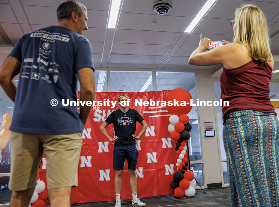 Toby Ekdale smiles for a photo with his parents inside University Suites. Residence hall move-in. Au