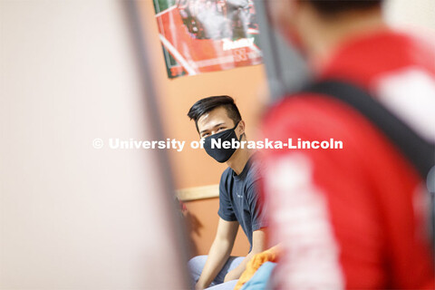 Photo shoot of students wearing masks and practicing social distancing in a University Suites Reside