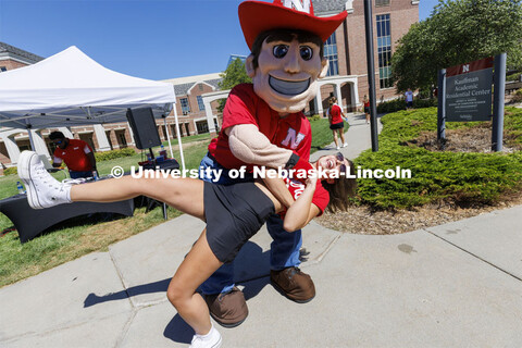 Herbie Husker dips Delanie Ferzely, a sophomore from Omaha, as they dance at the Student Tailgate an