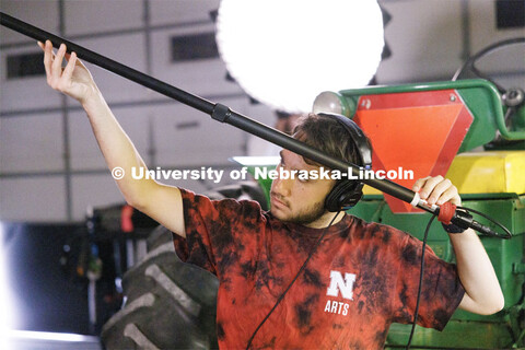 UNL student Isaiah Griffith holds a boom mic. Filming of the movie using UNL students as the product