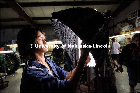Ethan Ma, a May UNL graduate, adjusts a grid on a light. He is interested in making his career in ci