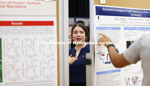 Dana Parker is seen describing her summer research through a gap in the poster easels. Undergraduate