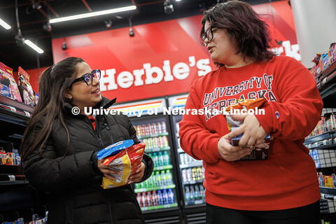 Maha Athar (left) talks with Luna Rivas, sophomore Integrated Science major, they walk down the aisl